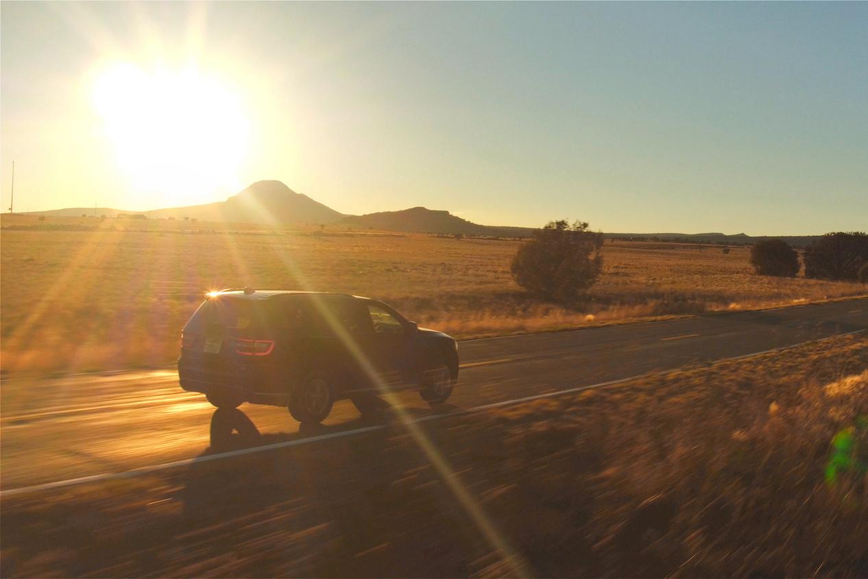 SUV driving down country road
